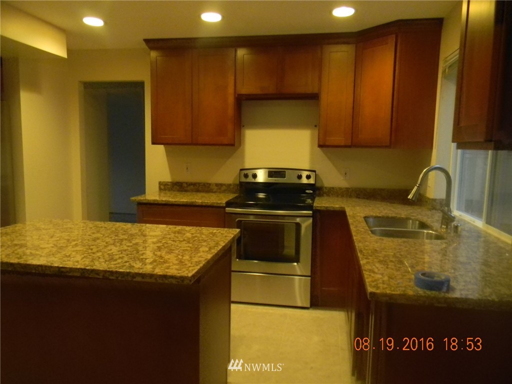 11224 Southeast 188th Place Renton, WA 98055 - Photo 4 of 16 a kitchen with a sink and cabinets