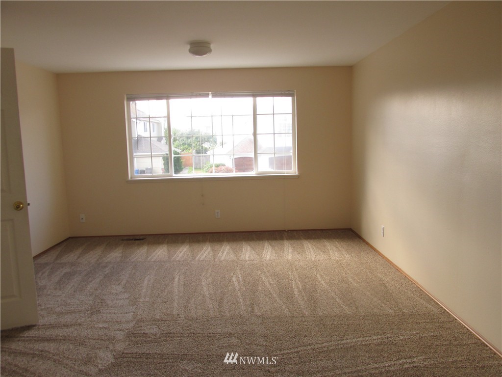 11224 Southeast 188th Place Renton, WA 98055 - Photo 10 of 16 an empty room with wooden floor and windows