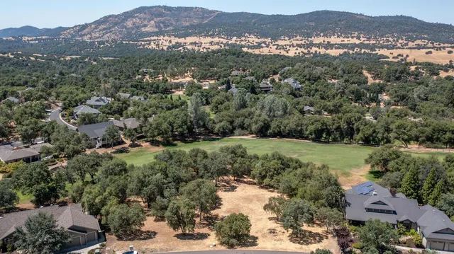an aerial view of mountain and residential houses