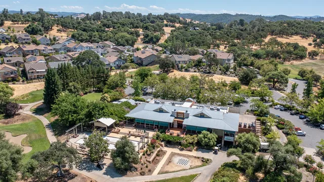an aerial view of a house with a yard