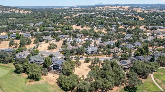 an aerial view of residential houses with city view