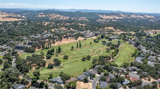 an aerial view of a houses with a city