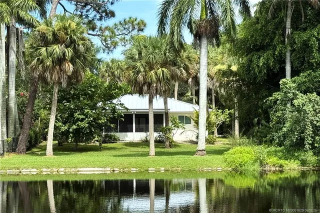 a view of a house with a yard table and chairs