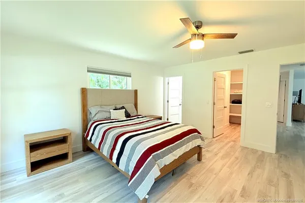 a bedroom with a bed and a chandelier