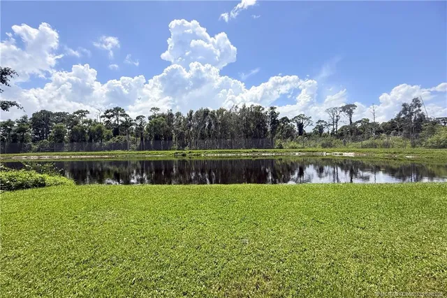 a view of a lake with houses in the background