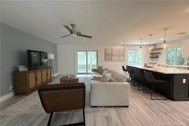 a living room with furniture flat screen tv and window