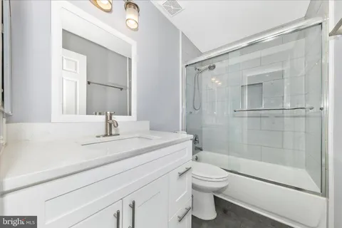 a view of a backyard with a bench and trees