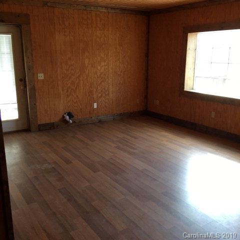 660 Rolands Chapel Road Nebo, NC 28761 - Photo 12 of 14 an empty room with wooden floor and windows
