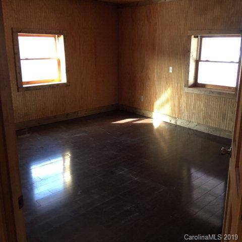 660 Rolands Chapel Road Nebo, NC 28761 - Photo 3 of 14 a view of an empty room with wooden floor and a window