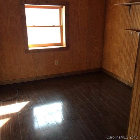 660 Rolands Chapel Road Nebo, NC 28761 - Photo 6 of 14 a view of an empty room with wooden floor and a window