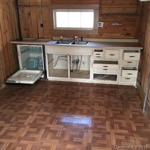 660 Rolands Chapel Road Nebo, NC 28761 - Photo 10 of 14 a view of kitchen with granite countertop white cabinets and stove