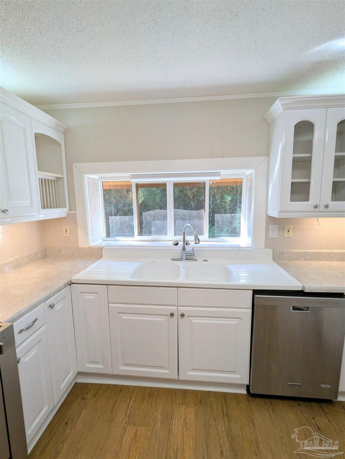 4301 Willow Street Pace, FL 32571 - Photo 14 of 25 a view of a sink and dishwasher with wooden floor
