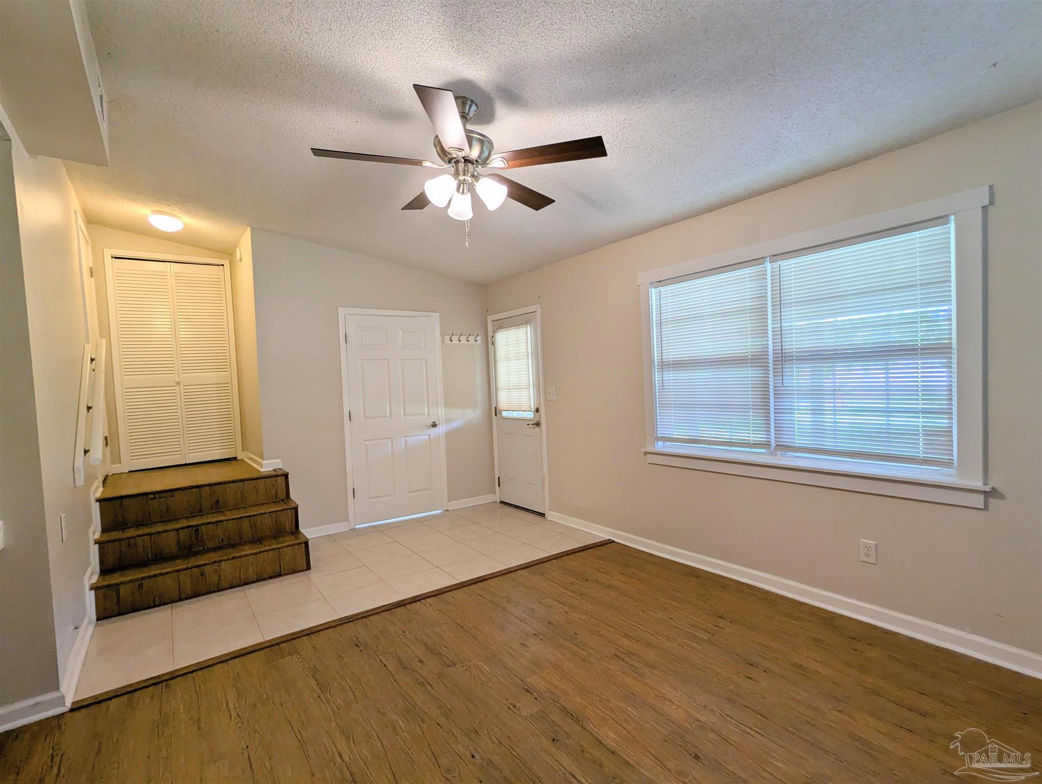 4301 Willow Street Pace, FL 32571 - Photo 17 of 25 a view of an empty room with wooden floor and a window
