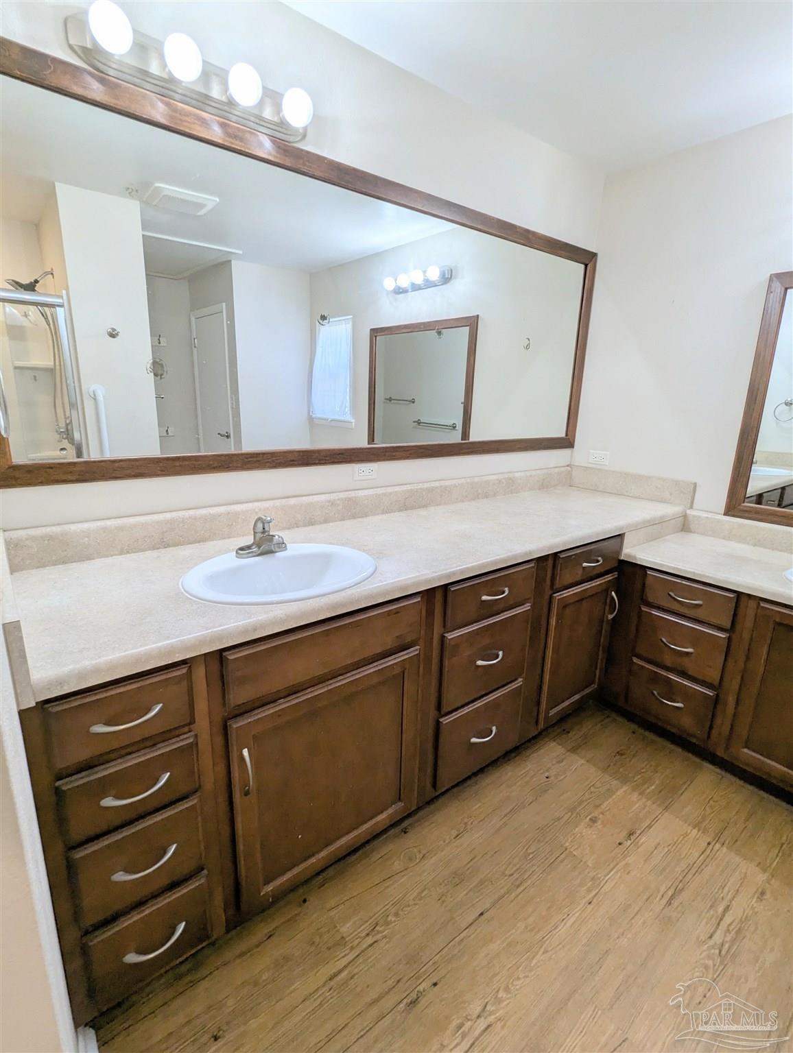 4301 Willow Street Pace, FL 32571 - Photo 18 of 25 a spacious bathroom with a granite countertop double vanity sink and a large mirror