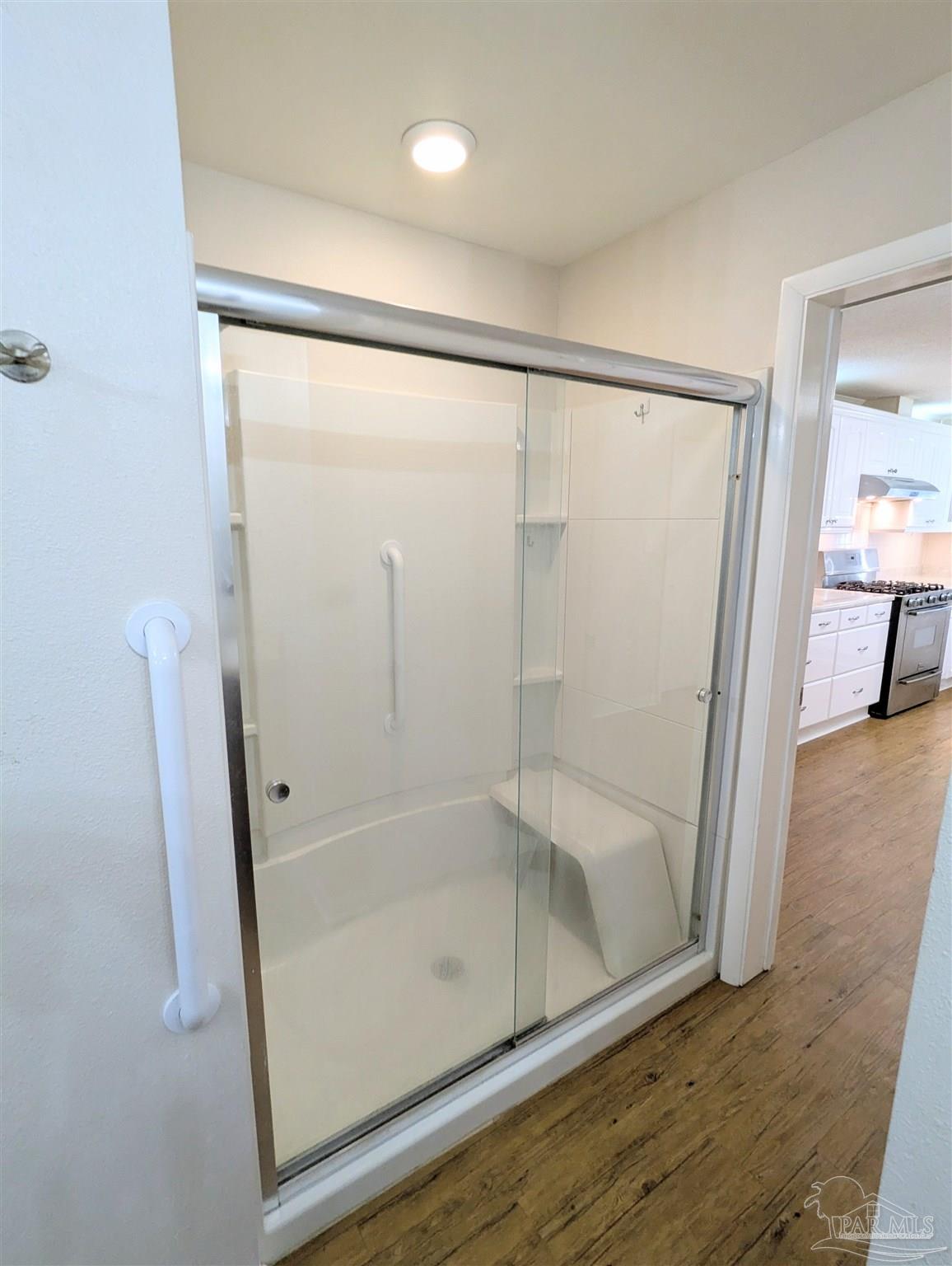 4301 Willow Street Pace, FL 32571 - Photo 19 of 25 a bathroom with a glass shower door