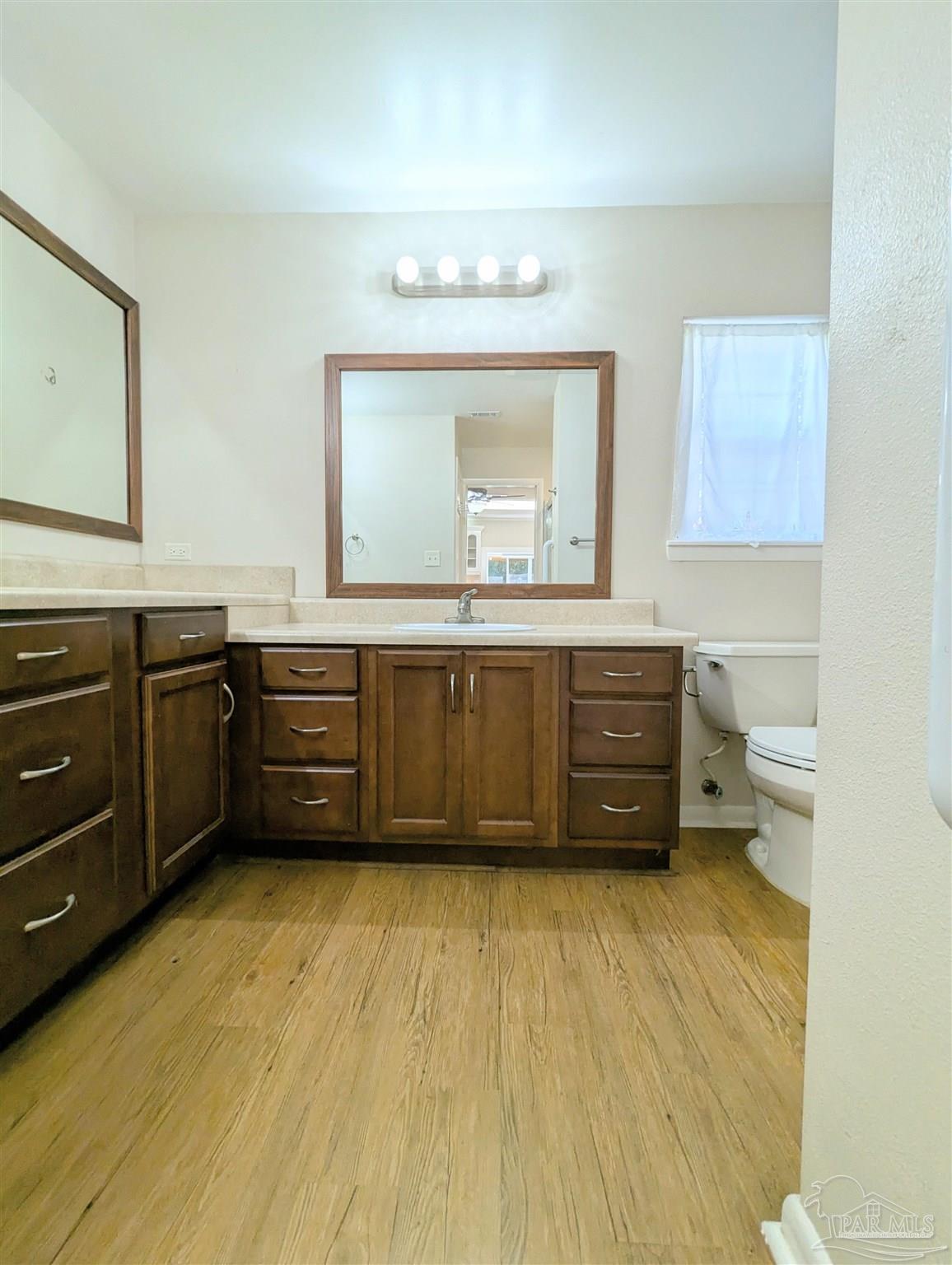 4301 Willow Street Pace, FL 32571 - Photo 20 of 25 a spacious bathroom with a sink double vanity and a mirror
