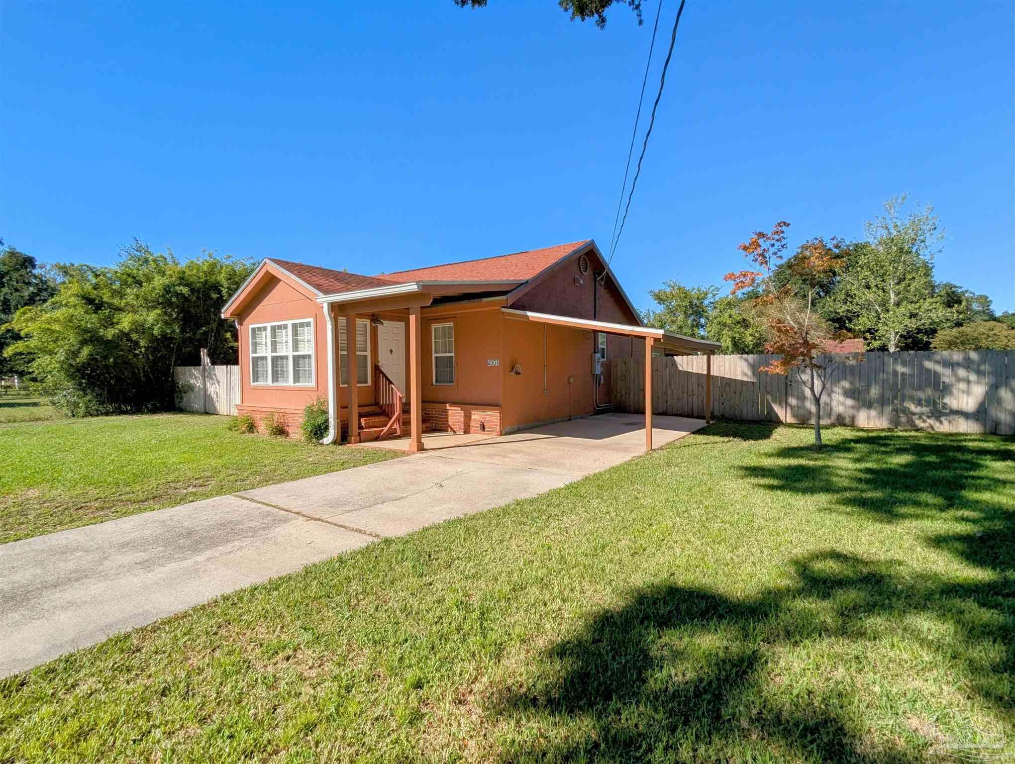 4301 Willow Street Pace, FL 32571 - Photo 2 of 25 a front view of a house with a garden and yard