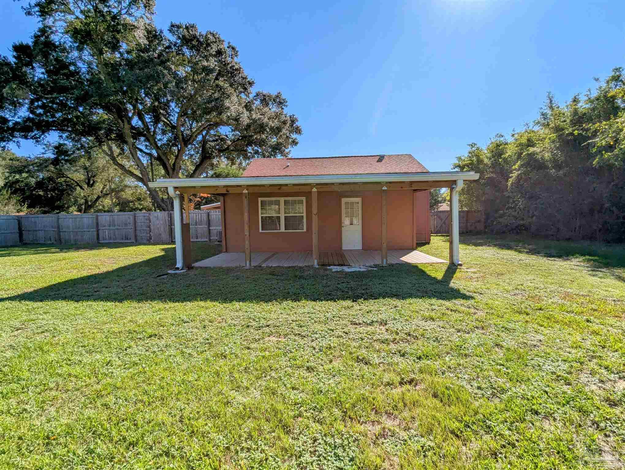 4301 Willow Street Pace, FL 32571 - Photo 22 of 25 a front view of a house with a yard and garage