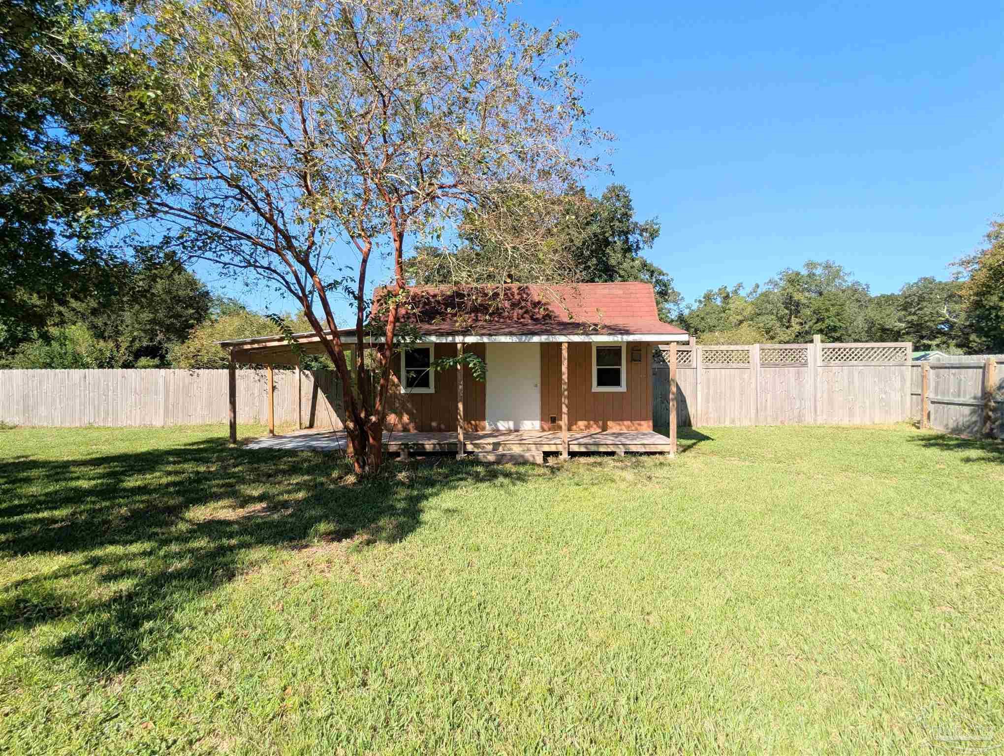 4301 Willow Street Pace, FL 32571 - Photo 24 of 25 a view of a house with backyard and sitting area