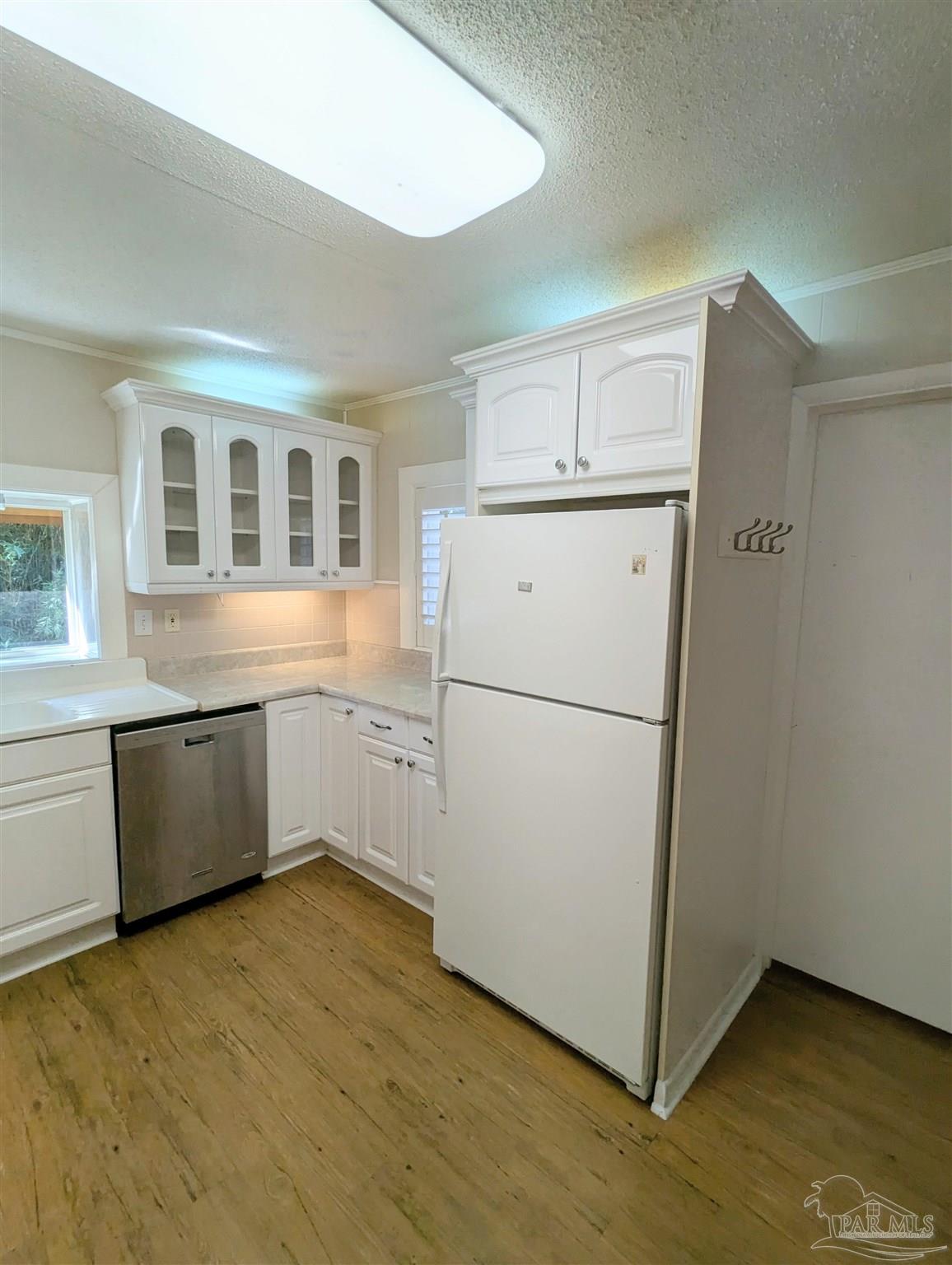4301 Willow Street Pace, FL 32571 - Photo 25 of 25 a kitchen with a refrigerator sink and cabinets