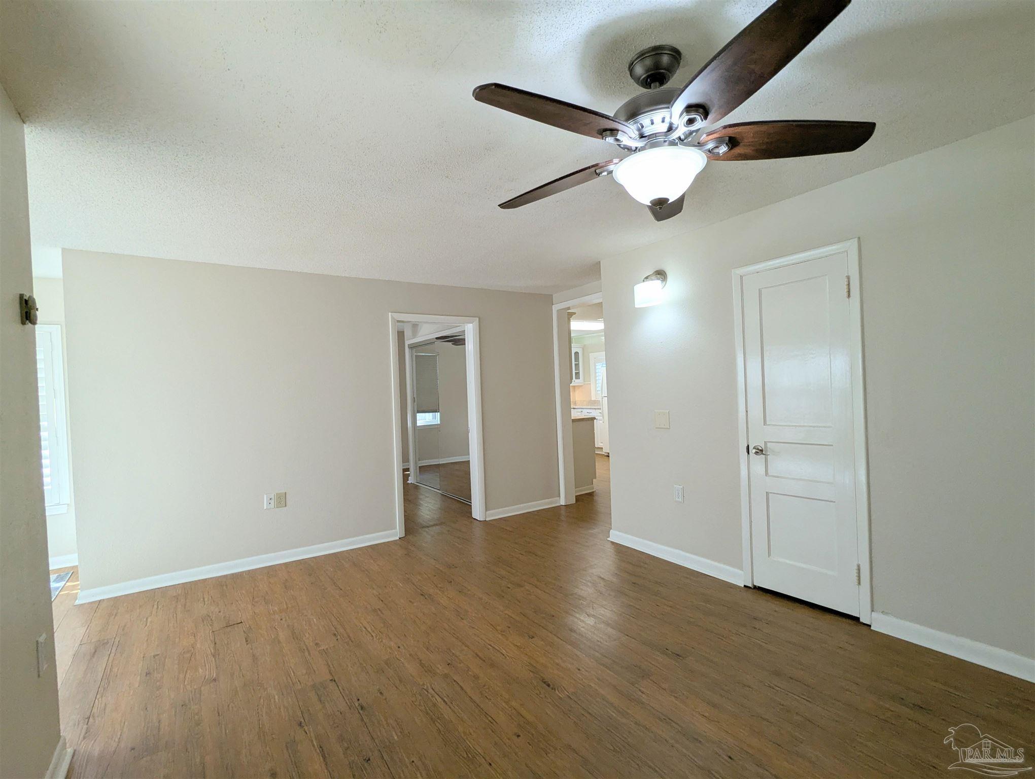 4301 Willow Street Pace, FL 32571 - Photo 6 of 25 a view of an empty room and wooden floor