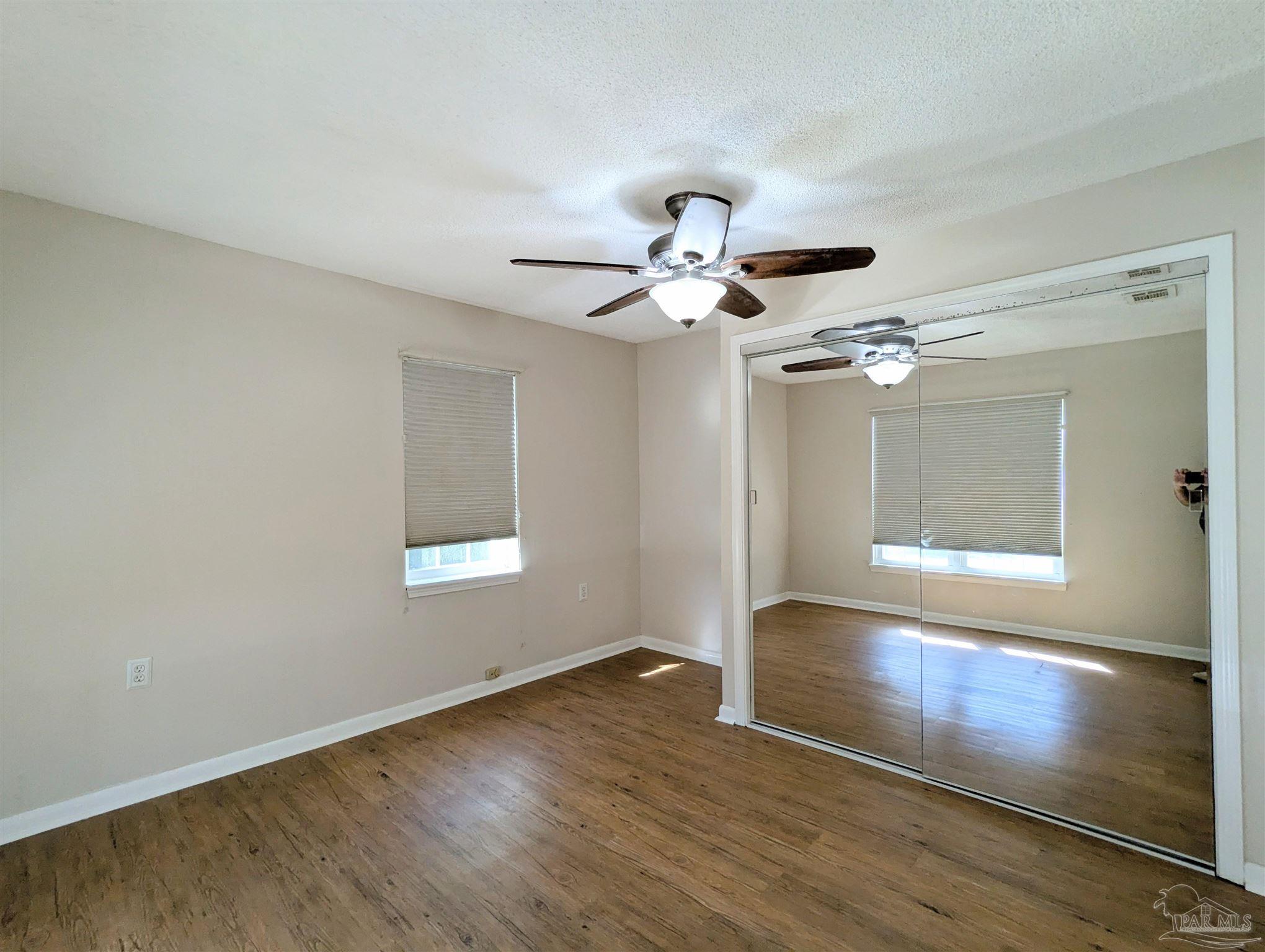 4301 Willow Street Pace, FL 32571 - Photo 9 of 25 a view of an empty room with a window and wooden floor