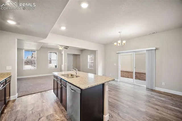 an open kitchen with sink and mirror