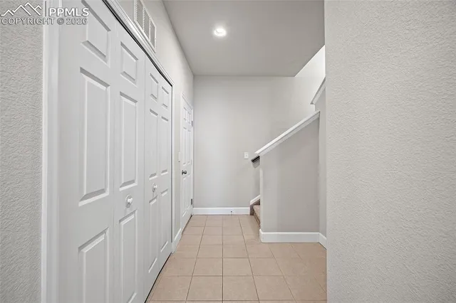 a view of a hallway with white walls