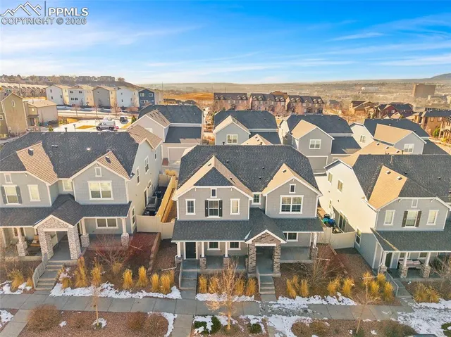 an aerial view of residential houses with city view