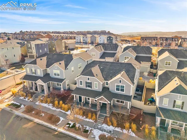 an aerial view of residential houses with outdoor space