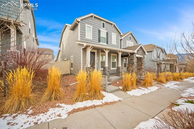 a view of a brick house with a yard