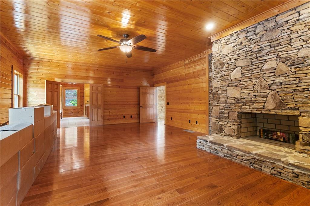 729 Huckleberry Way Jasper, GA 30143 - Photo 41 of 74 a view of empty room with wooden floor and fireplace