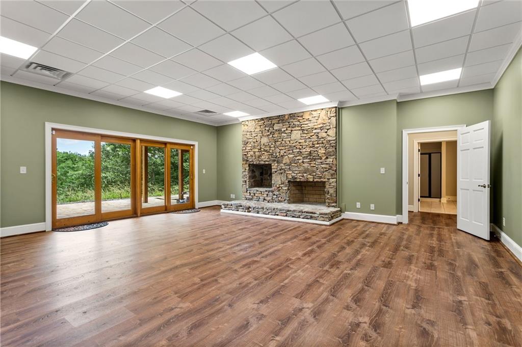 729 Huckleberry Way Jasper, GA 30143 - Photo 49 of 74 a view of an empty room with wooden floor and a fireplace