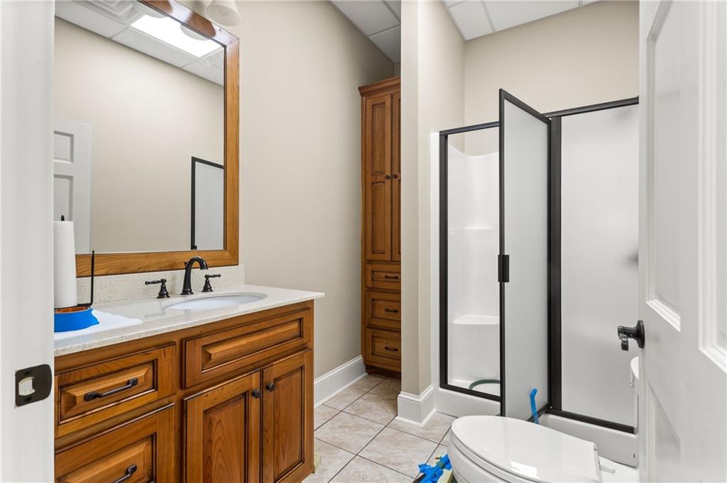 729 Huckleberry Way Jasper, GA 30143 - Photo 51 of 74 a bathroom with a granite countertop sink toilet and shower