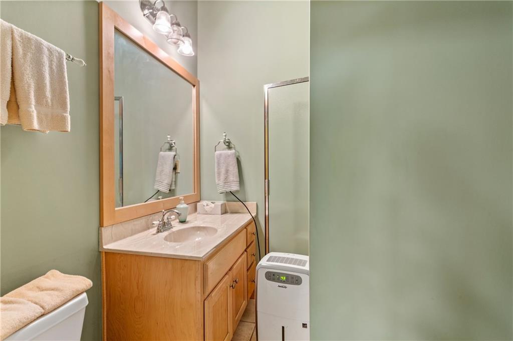 729 Huckleberry Way Jasper, GA 30143 - Photo 53 of 74 a bathroom with a sink mirror and vanity