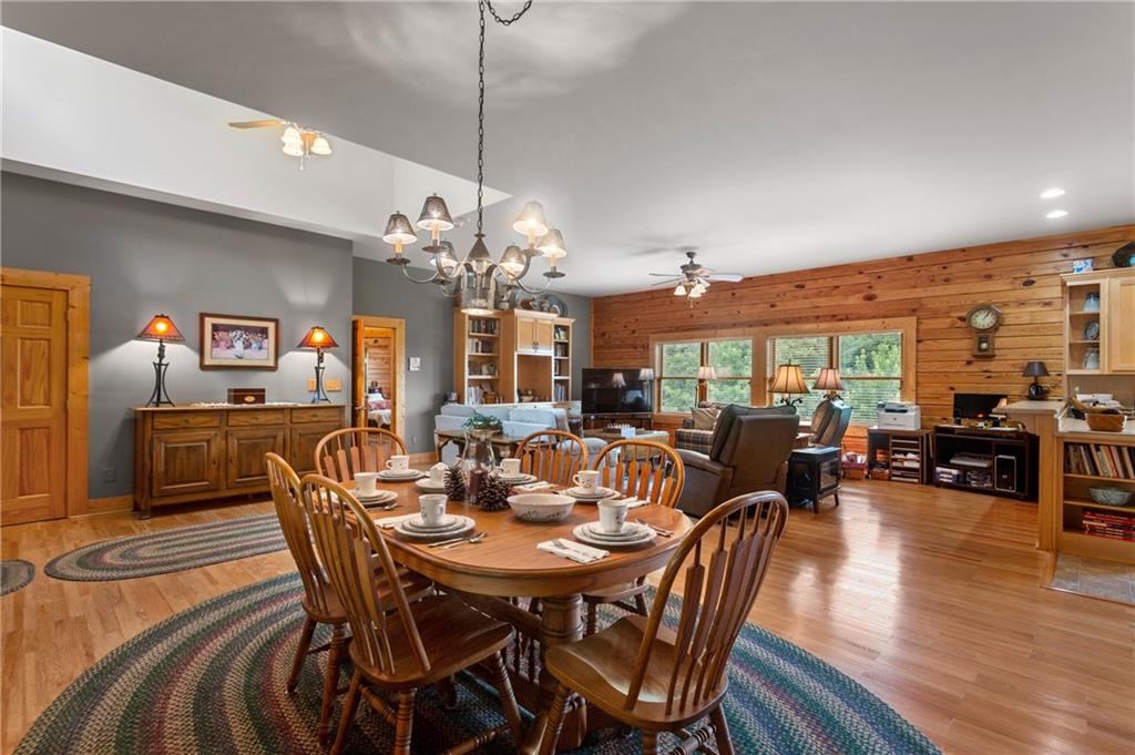 729 Huckleberry Way Jasper, GA 30143 - Photo 7 of 74 a view of a dining room and livingroom with furniture wooden floor a chandelier fan a wooden table and chairs