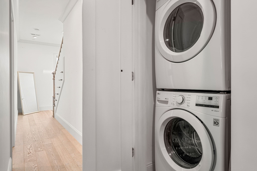 251 Minot Street, Unit 6 Boston, MA 02124 - Photo 13 of 30 a view of a hallway with washer and dryer