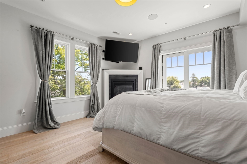 251 Minot Street, Unit 6 Boston, MA 02124 - Photo 15 of 30 a bedroom with a bed and a fireplace