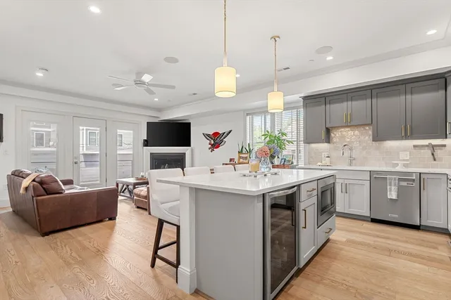 a kitchen with kitchen island granite countertop a sink and a stove