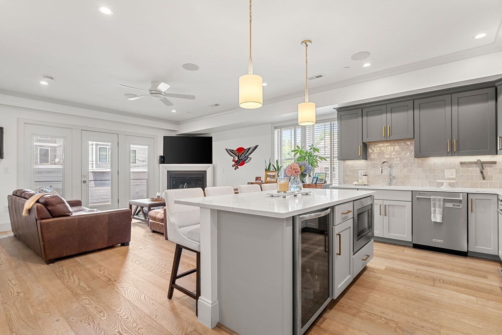 251 Minot Street, Unit 6 Boston, MA 02124 - Photo 4 of 30 a kitchen with kitchen island granite countertop a sink and a stove