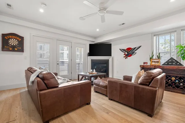a living room with furniture a fireplace and a flat screen tv