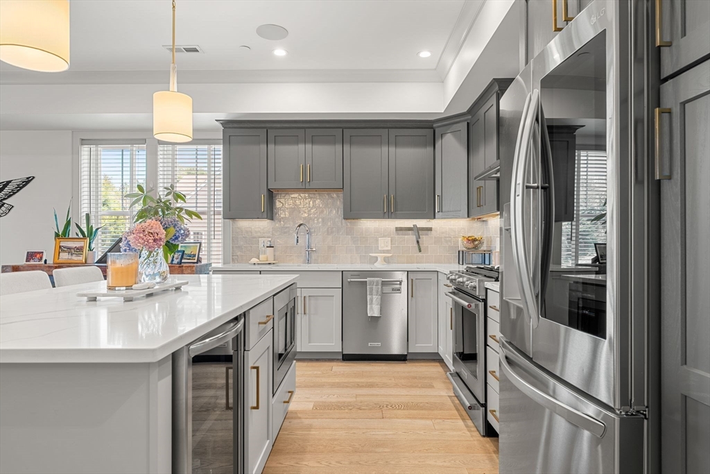 251 Minot Street, Unit 6 Boston, MA 02124 - Photo 10 of 30 a kitchen with kitchen island granite countertop a sink stainless steel appliances and cabinets