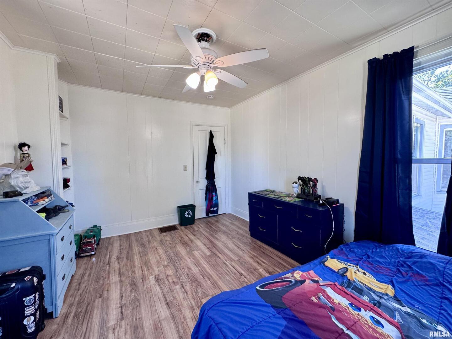 1415 4th Street Fulton, IL 61252 - Photo 48 of 58 a bedroom with a bed and wooden floor