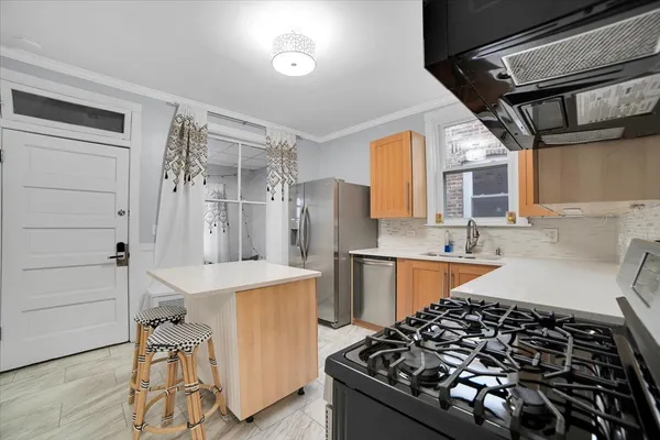 a kitchen with a stove a sink and a refrigerator