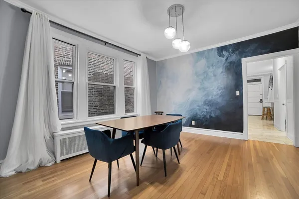 a view of a dining room with furniture and wooden floor