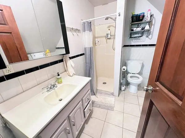 a bathroom with a sink toilet and shower