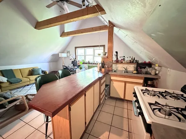 a kitchen with stainless steel appliances kitchen island a large counter space a sink and a stove