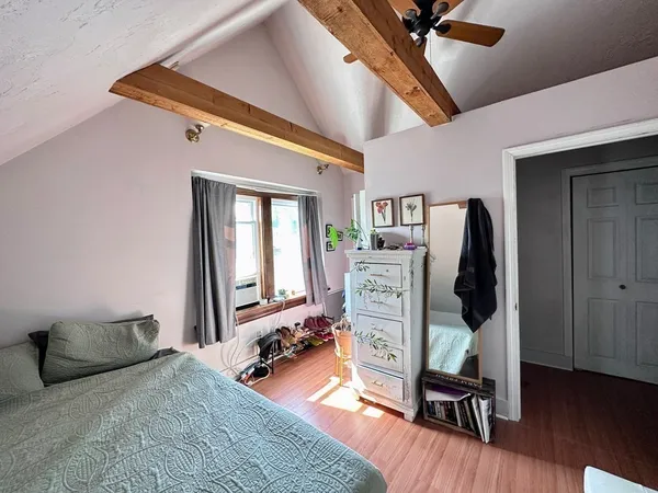 a bedroom with furniture and a window