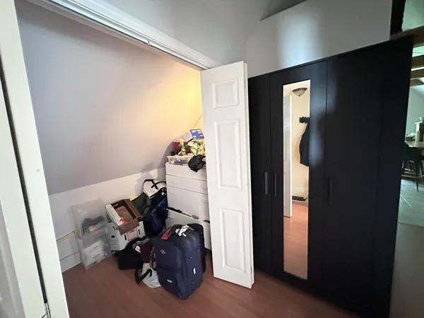 a room with wooden floor and a window