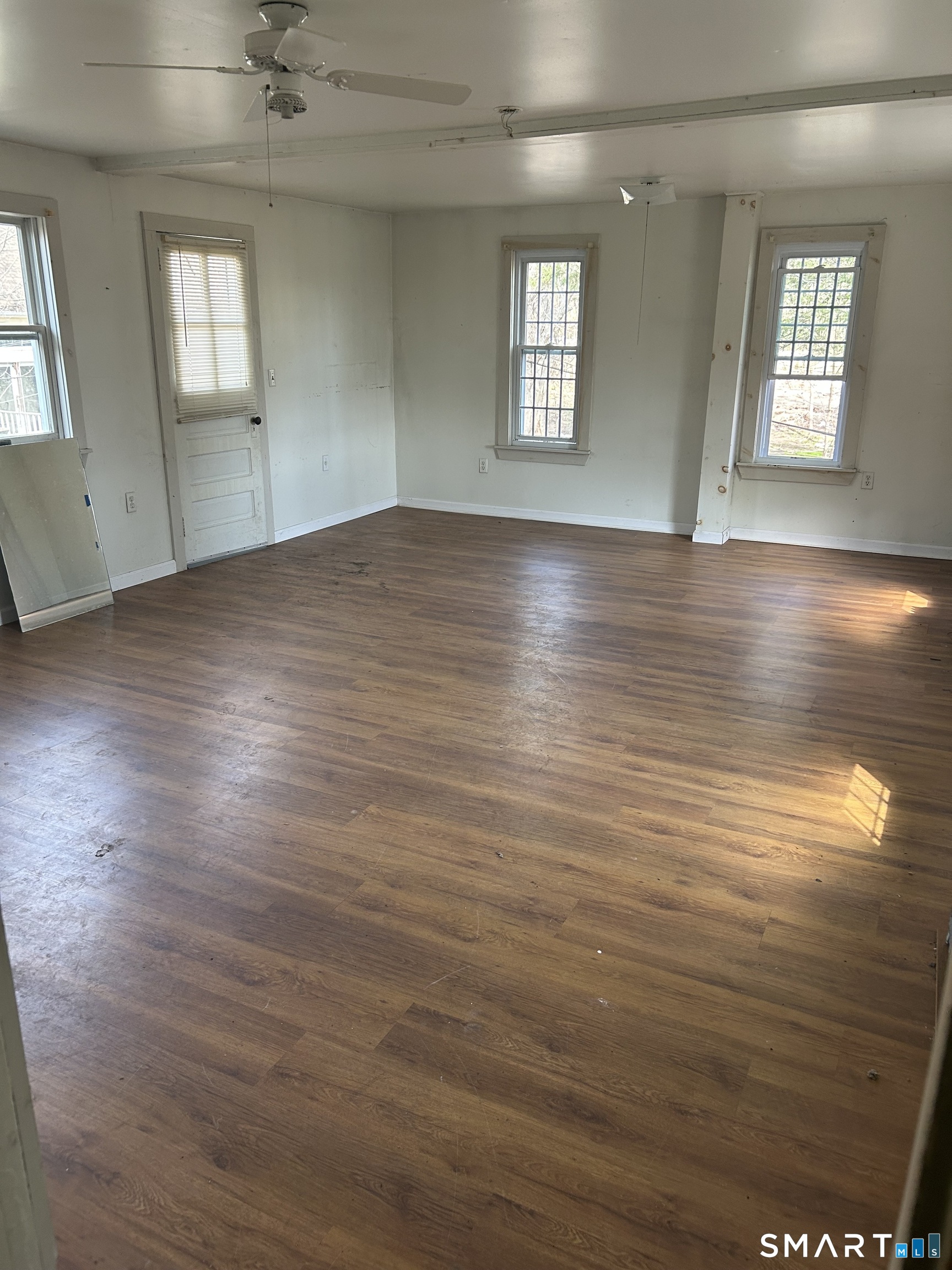 134 Sillimanville Road East Haddam, CT 06469 - Photo 11 of 27 an empty room with wooden floor and windows
